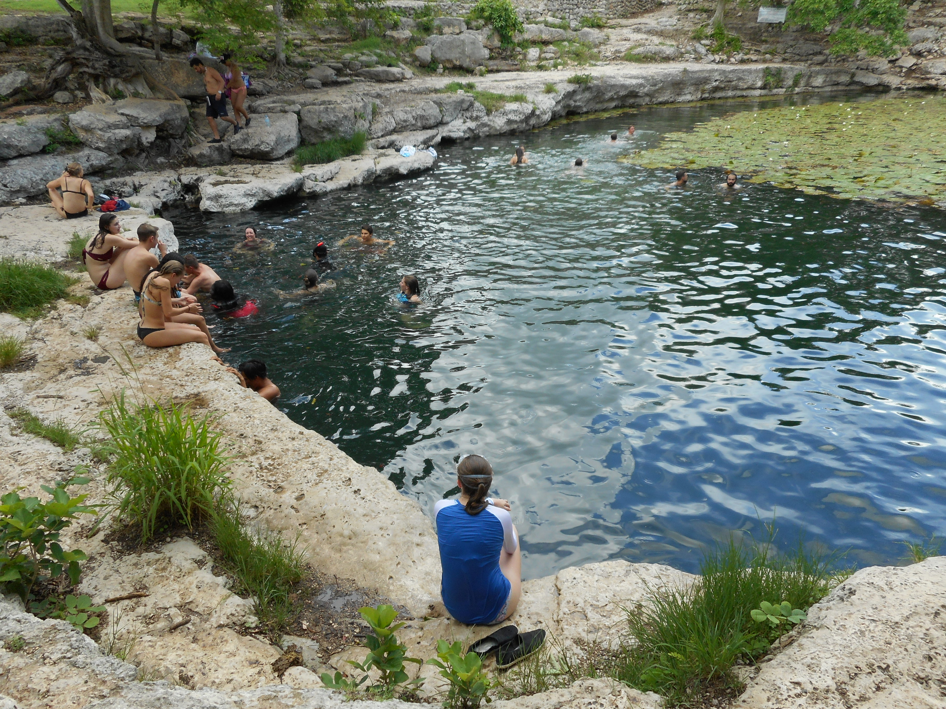 Students swimming in Cenote Xlakah