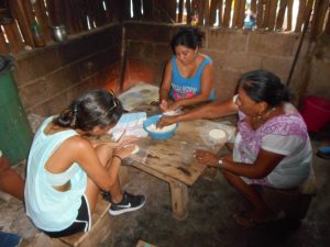 A student learns how to make tortillas from the “pros” at Ek Balam.