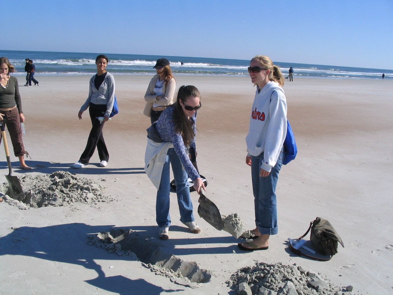 Picture of students playing with sand in bahama beach